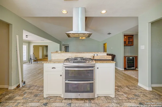 a kitchen with a stove and a refrigerator