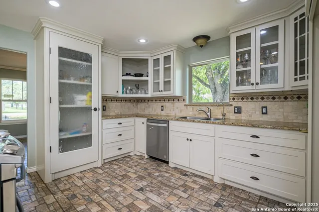 a spacious bathroom with a granite countertop sink mirror and window