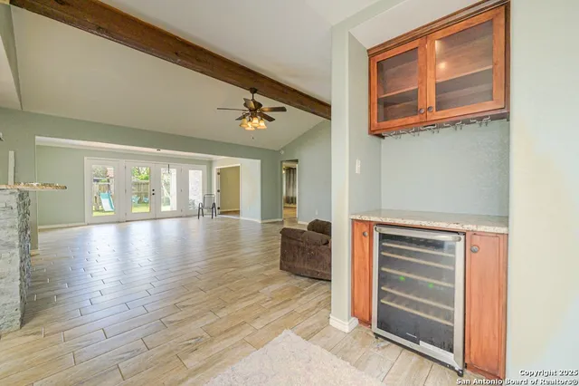 a view of a livingroom with furniture and chandelier fan