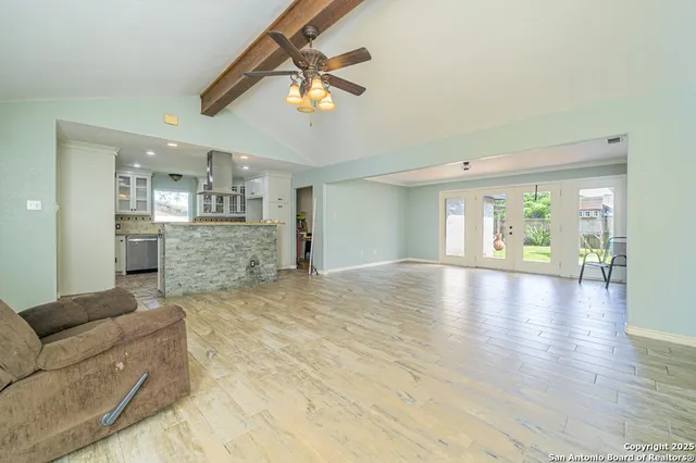 a view of empty room with wooden floor