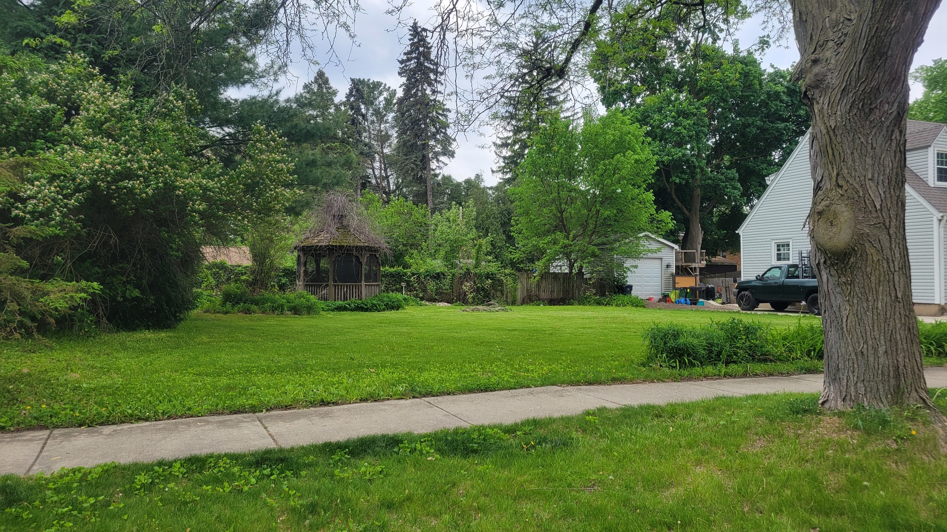 Vacant Lot Parcel 1 Vacant Congdon Avenue Elgin, IL 60120 - Photo 2 of 4 a front view of a house with a yard and tree