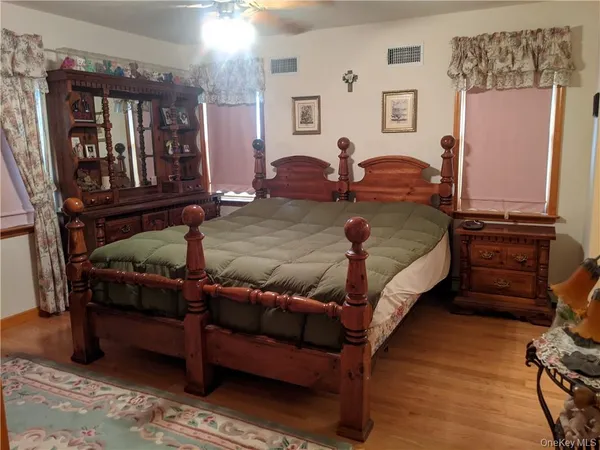 a bed room with a bed window and dresser