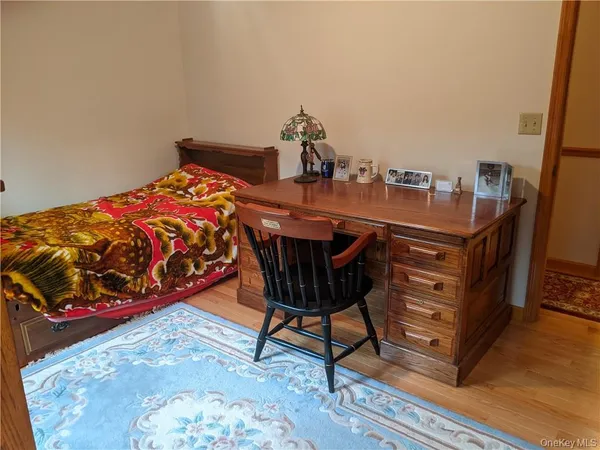 a bedroom with a bed and a dresser