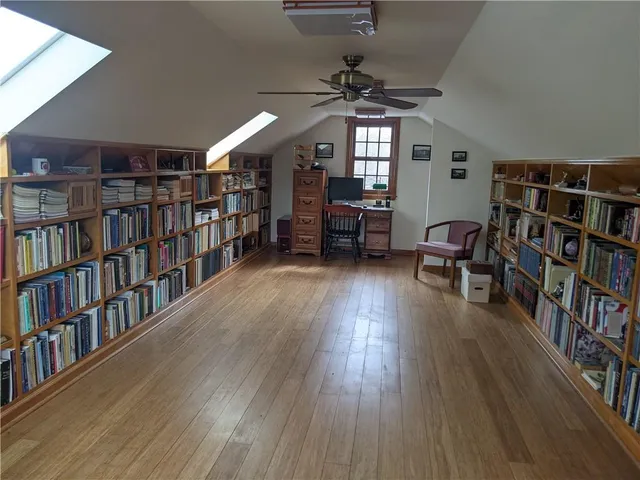 a living room with lots of furniture and a book shelf