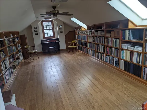 a living room with lots of furniture and a book shelf