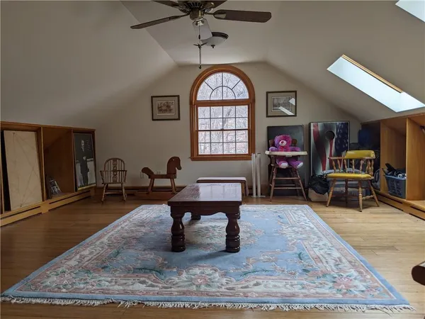 a living room with furniture a rug and white walls