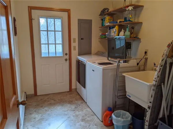 a room with a sink storage and utility