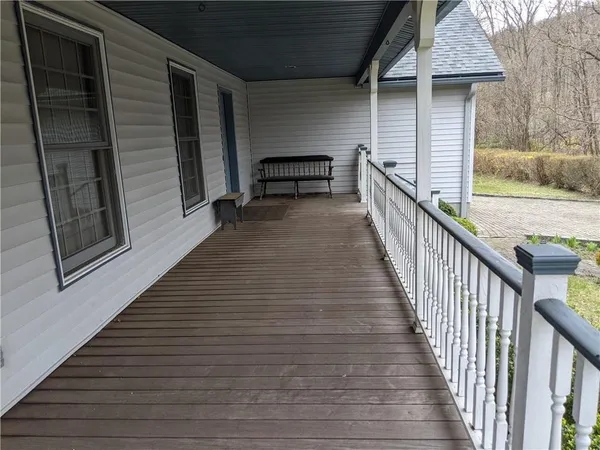 a view of a balcony with wooden floor and stairs