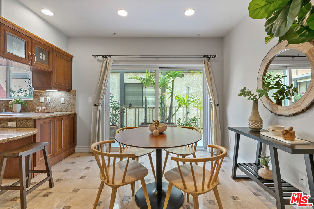 1747 South Barrington Avenue, Unit 103 Los Angeles, CA 90025 - Photo 13 of 45 a dining room with furniture and window
