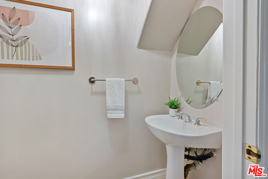 1747 South Barrington Avenue, Unit 103 Los Angeles, CA 90025 - Photo 14 of 45 a bathroom with a sink and a mirror
