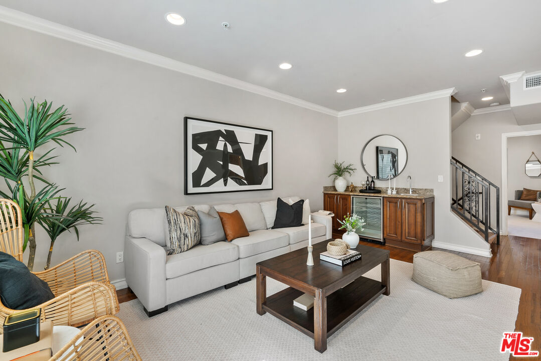 1747 South Barrington Avenue, Unit 103 Los Angeles, CA 90025 - Photo 16 of 45 a living room with furniture potted plant and a lamp