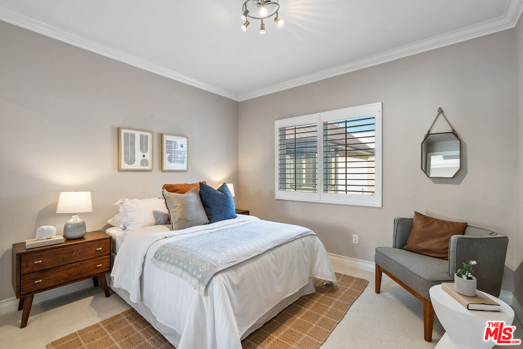 1747 South Barrington Avenue, Unit 103 Los Angeles, CA 90025 - Photo 18 of 45 a bed room with a bed and a couch