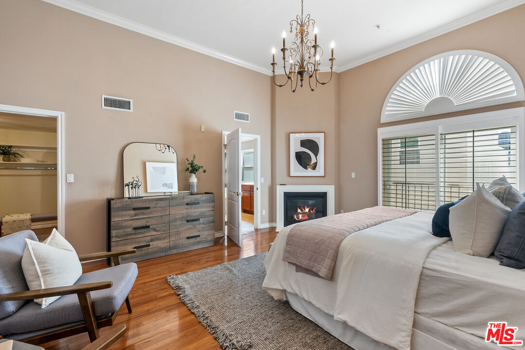 1747 South Barrington Avenue, Unit 103 Los Angeles, CA 90025 - Photo 22 of 45 a bedroom with a bed and a chandelier