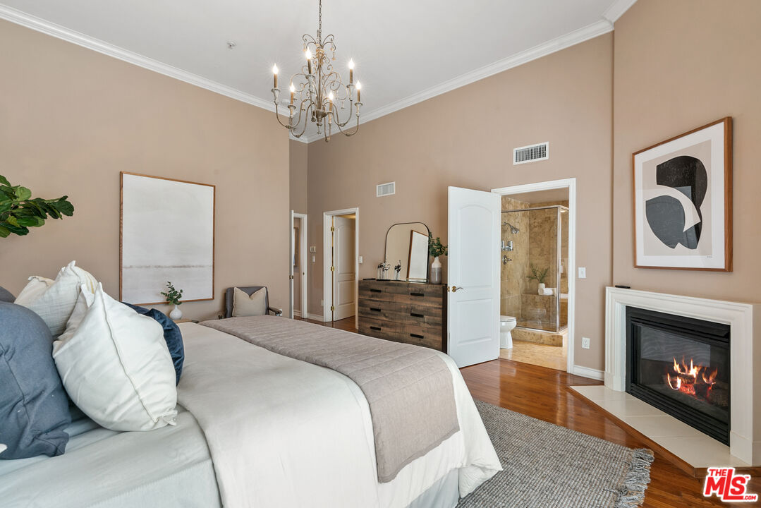1747 South Barrington Avenue, Unit 103 Los Angeles, CA 90025 - Photo 23 of 45 a spacious bedroom with a bed and a fireplace