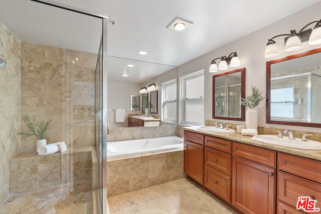 1747 South Barrington Avenue, Unit 103 Los Angeles, CA 90025 - Photo 25 of 45 a large bathroom with a double vanity sink mirror and bathtub