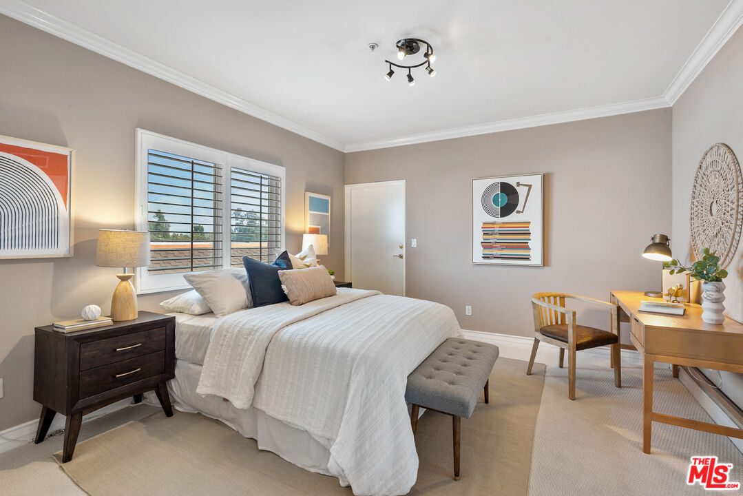 1747 South Barrington Avenue, Unit 103 Los Angeles, CA 90025 - Photo 28 of 45 a bedroom with a bed and a table in it