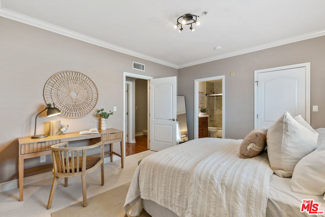 1747 South Barrington Avenue, Unit 103 Los Angeles, CA 90025 - Photo 29 of 45 a bedroom with a bed a table and chair