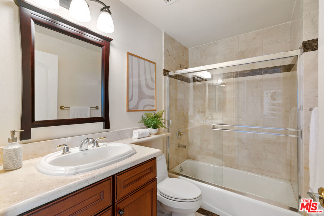 1747 South Barrington Avenue, Unit 103 Los Angeles, CA 90025 - Photo 30 of 45 a bathroom with a sink toilet and shower