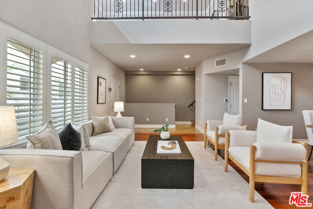 1747 South Barrington Avenue, Unit 103 Los Angeles, CA 90025 - Photo 3 of 45 a living room with furniture and a large window