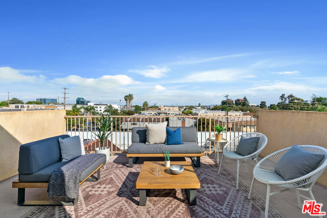 1747 South Barrington Avenue, Unit 103 Los Angeles, CA 90025 - Photo 32 of 45 a view of a roof deck with couches and potted plants