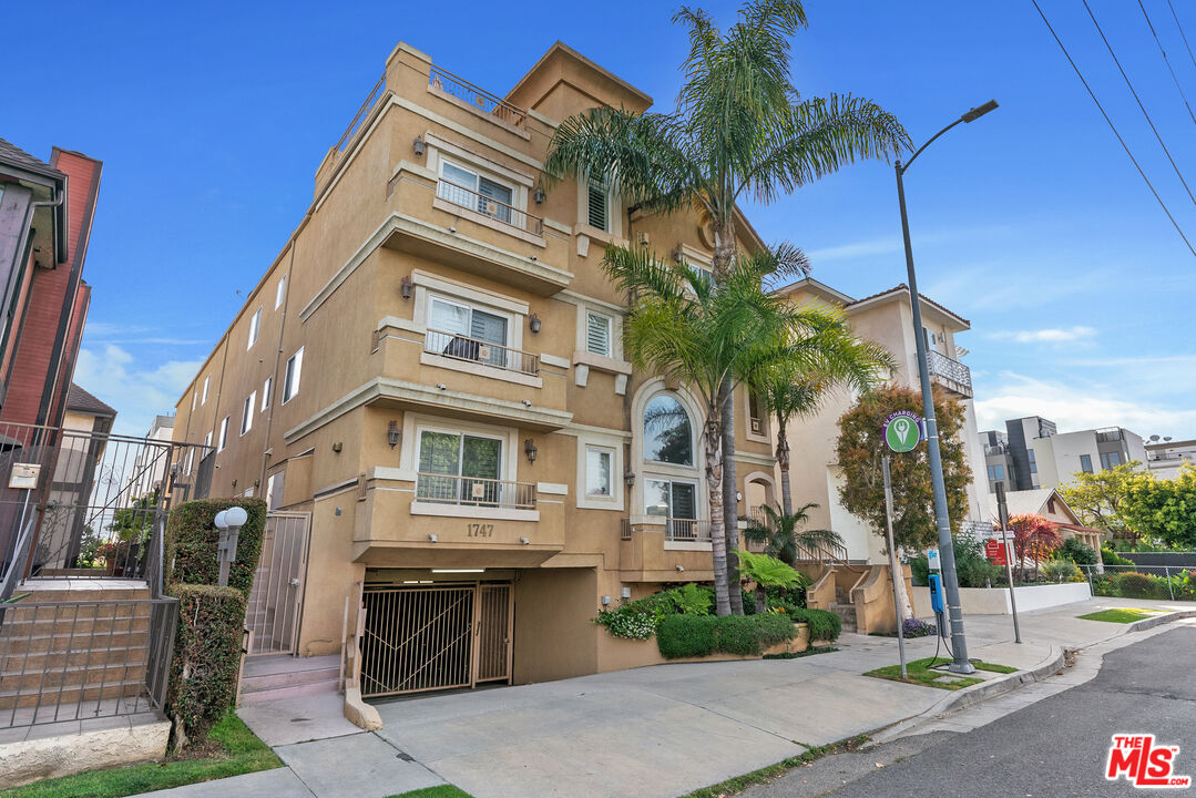 1747 South Barrington Avenue, Unit 103 Los Angeles, CA 90025 - Photo 35 of 45 a view of a house with a yard and potted plants