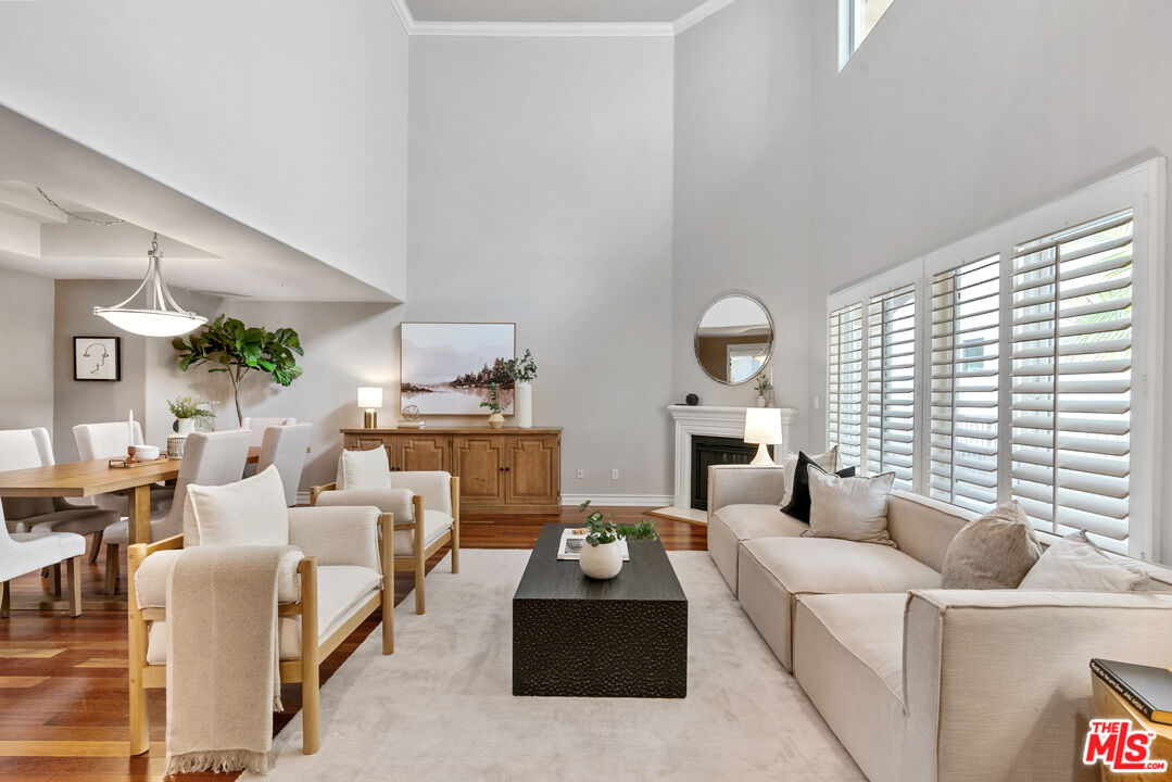 1747 South Barrington Avenue, Unit 103 Los Angeles, CA 90025 - Photo 4 of 45 a living room with furniture and a large window