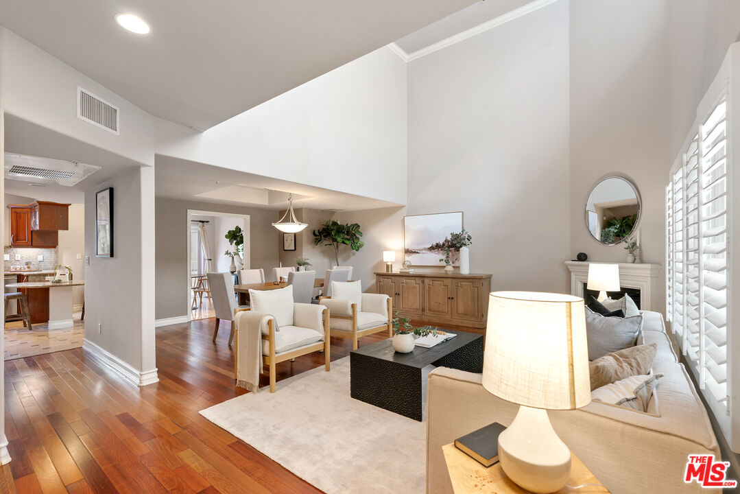 1747 South Barrington Avenue, Unit 103 Los Angeles, CA 90025 - Photo 5 of 45 a living room with furniture and a wooden floor
