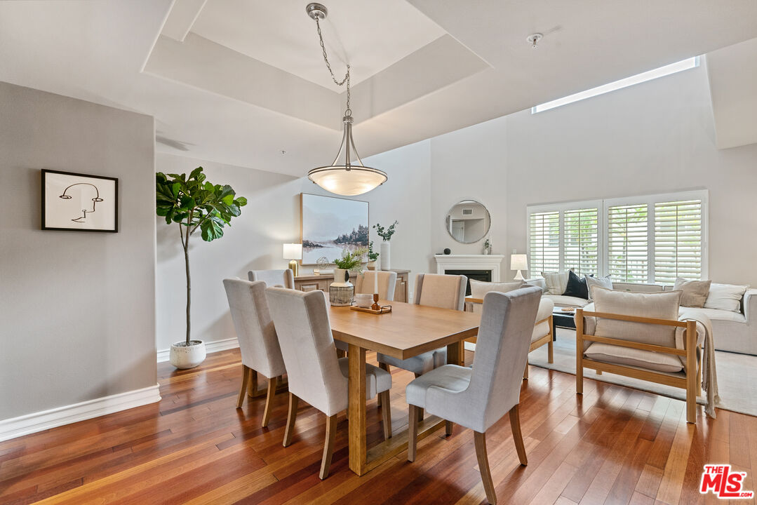 1747 South Barrington Avenue, Unit 103 Los Angeles, CA 90025 - Photo 6 of 45 a view of a dining room with furniture window and wooden floor