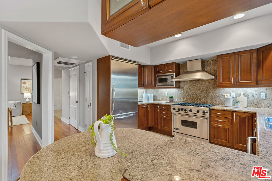 1747 South Barrington Avenue, Unit 103 Los Angeles, CA 90025 - Photo 10 of 45 a kitchen with stainless steel appliances granite countertop a sink stove and refrigerator