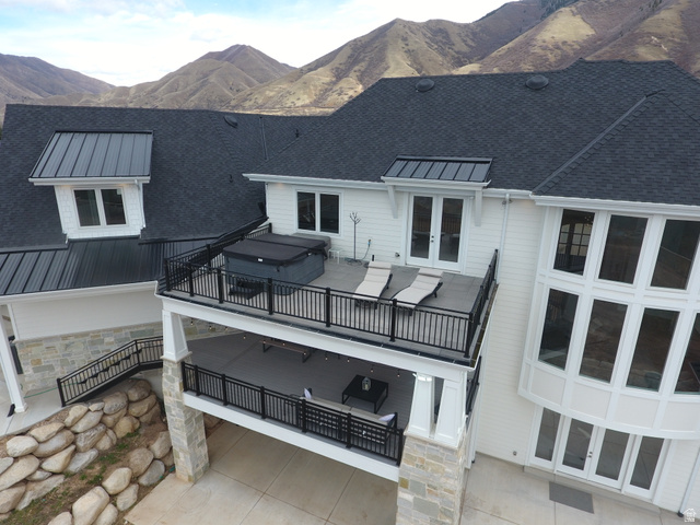 1354 South 800 East Mapleton, UT 84664 - Photo 115 of 129 Back of house with french doors, stone siding, a patio area, a mountain view, and a standing seam roof