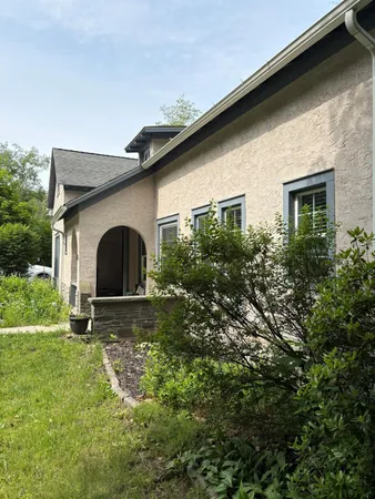 a front view of house with yard and green space
