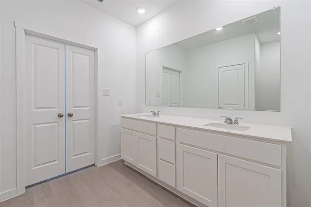 a bathroom with 2 sink and a mirror