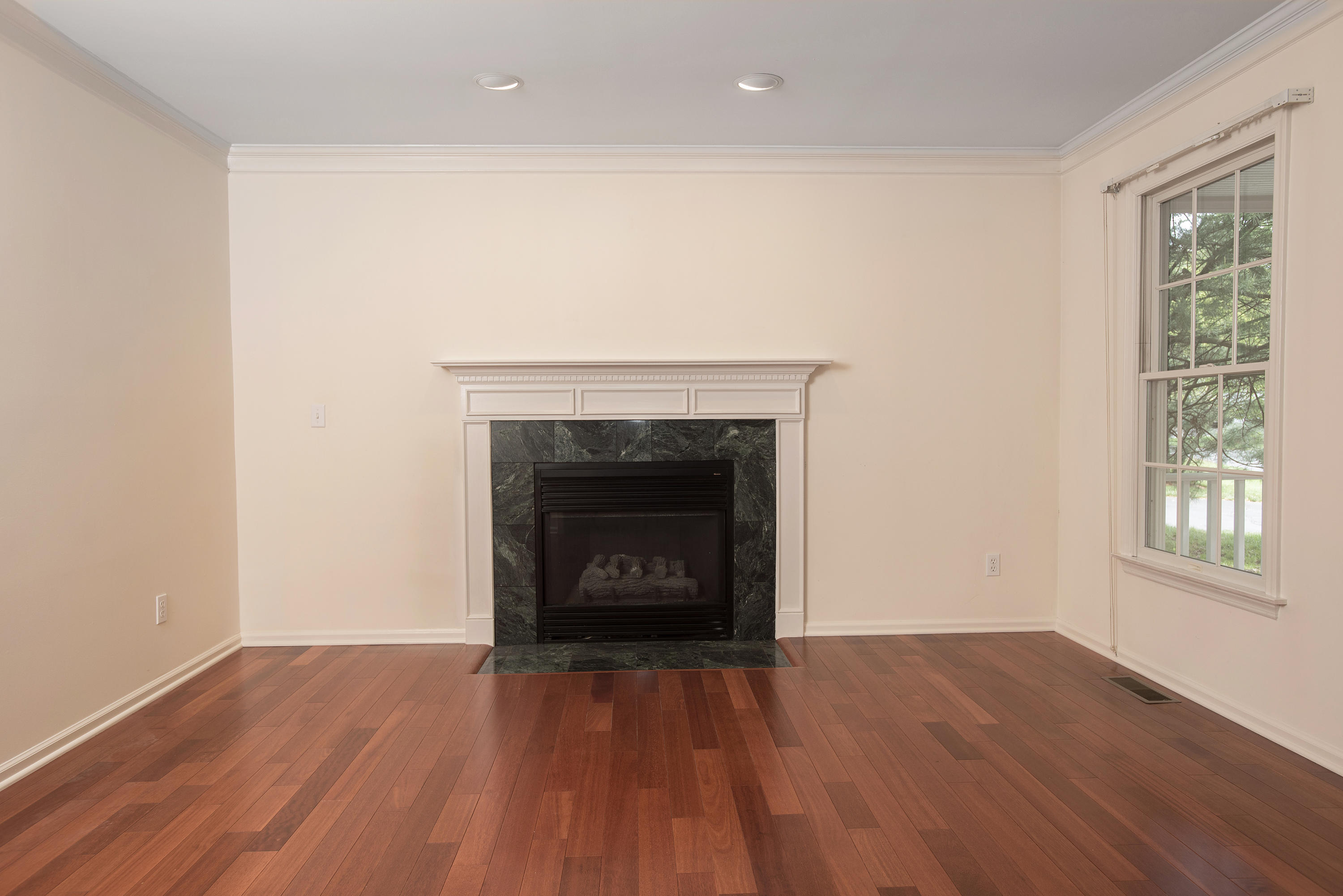 17 Getner Trail, Unit 17 Norwalk, CT 06854 - Photo 12 of 33 an empty room with wooden floor fireplace and windows