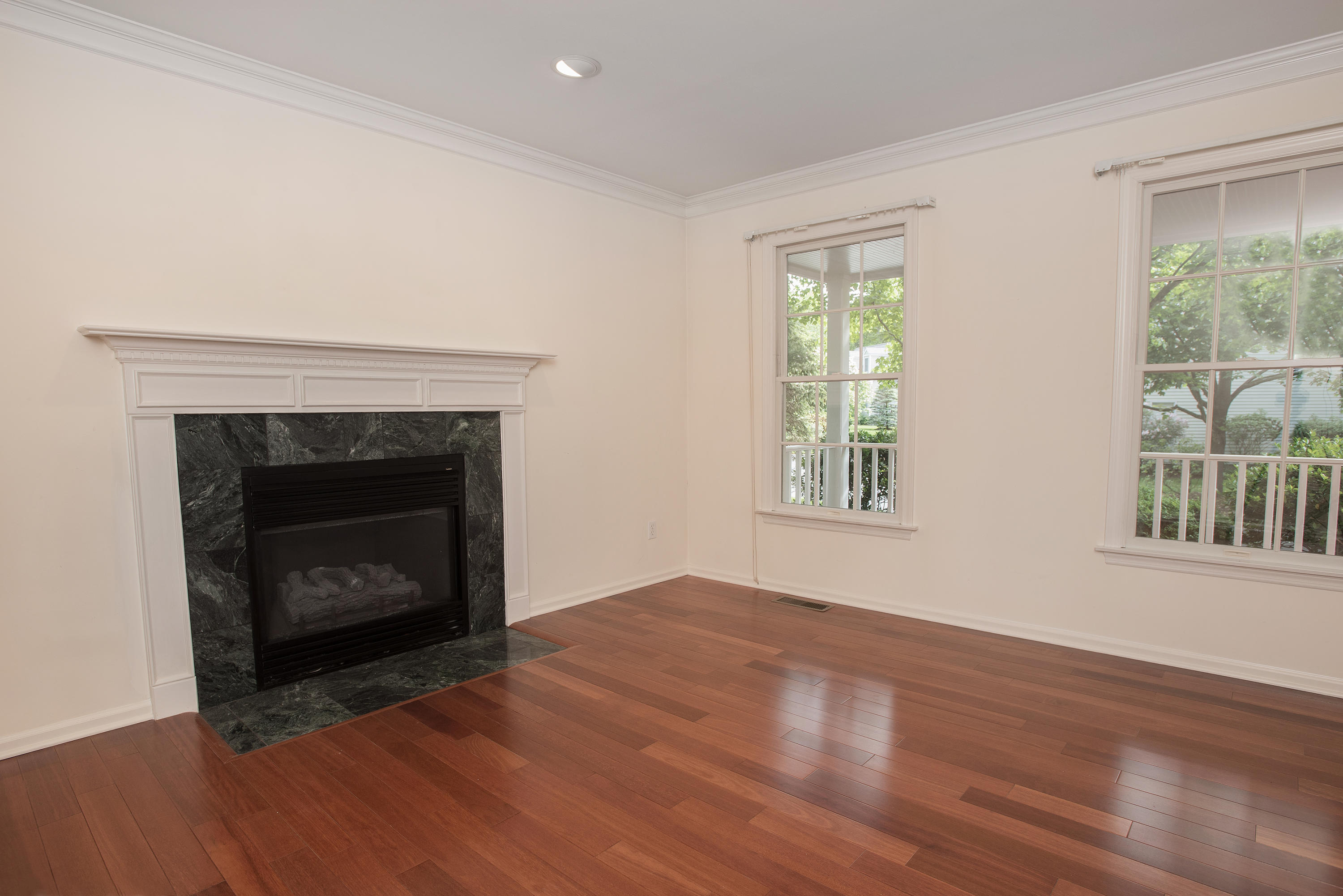 17 Getner Trail, Unit 17 Norwalk, CT 06854 - Photo 13 of 33 a view of an empty room with wooden floor fireplace and a window