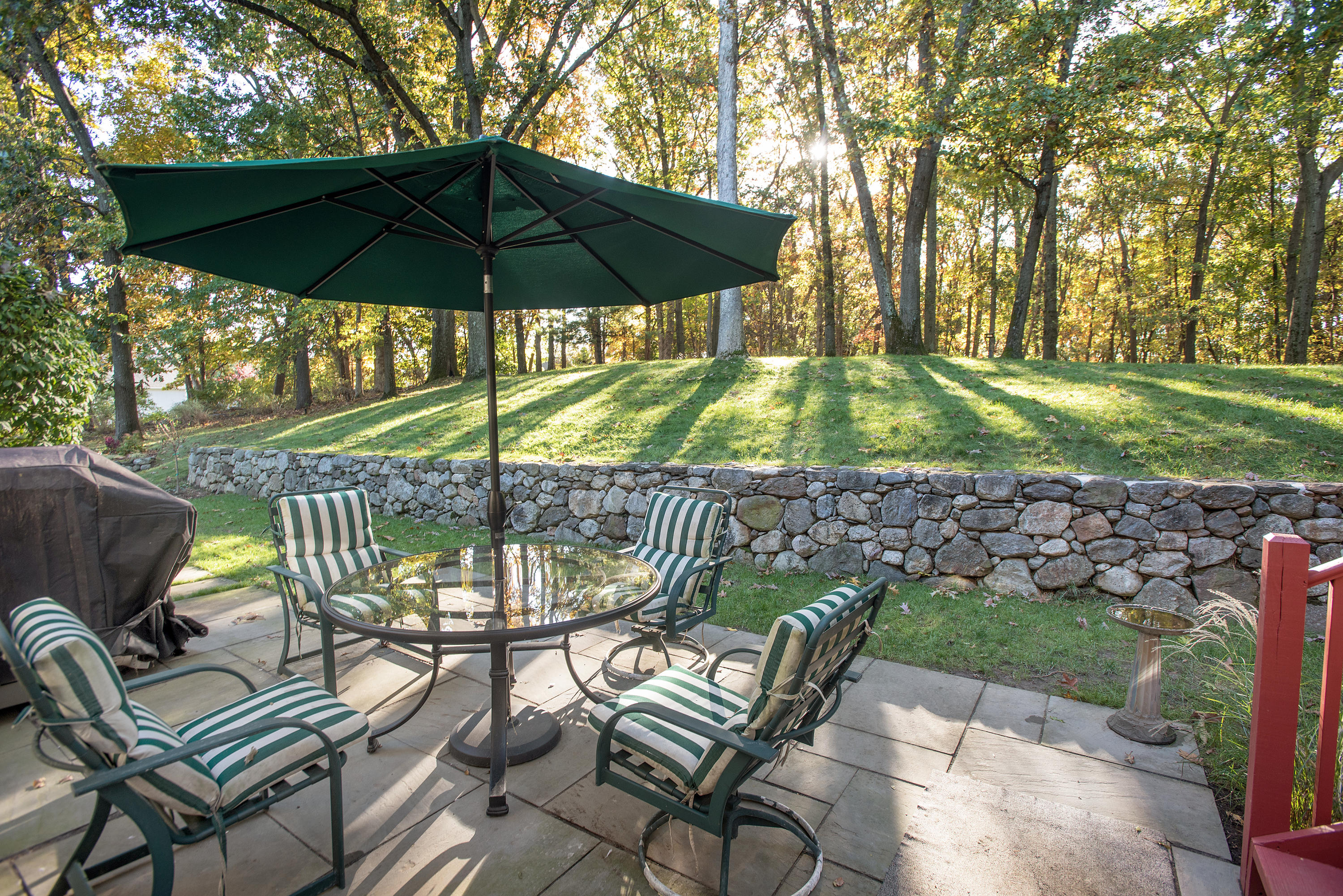 17 Getner Trail, Unit 17 Norwalk, CT 06854 - Photo 28 of 33 a view of a table and chairs under an umbrella