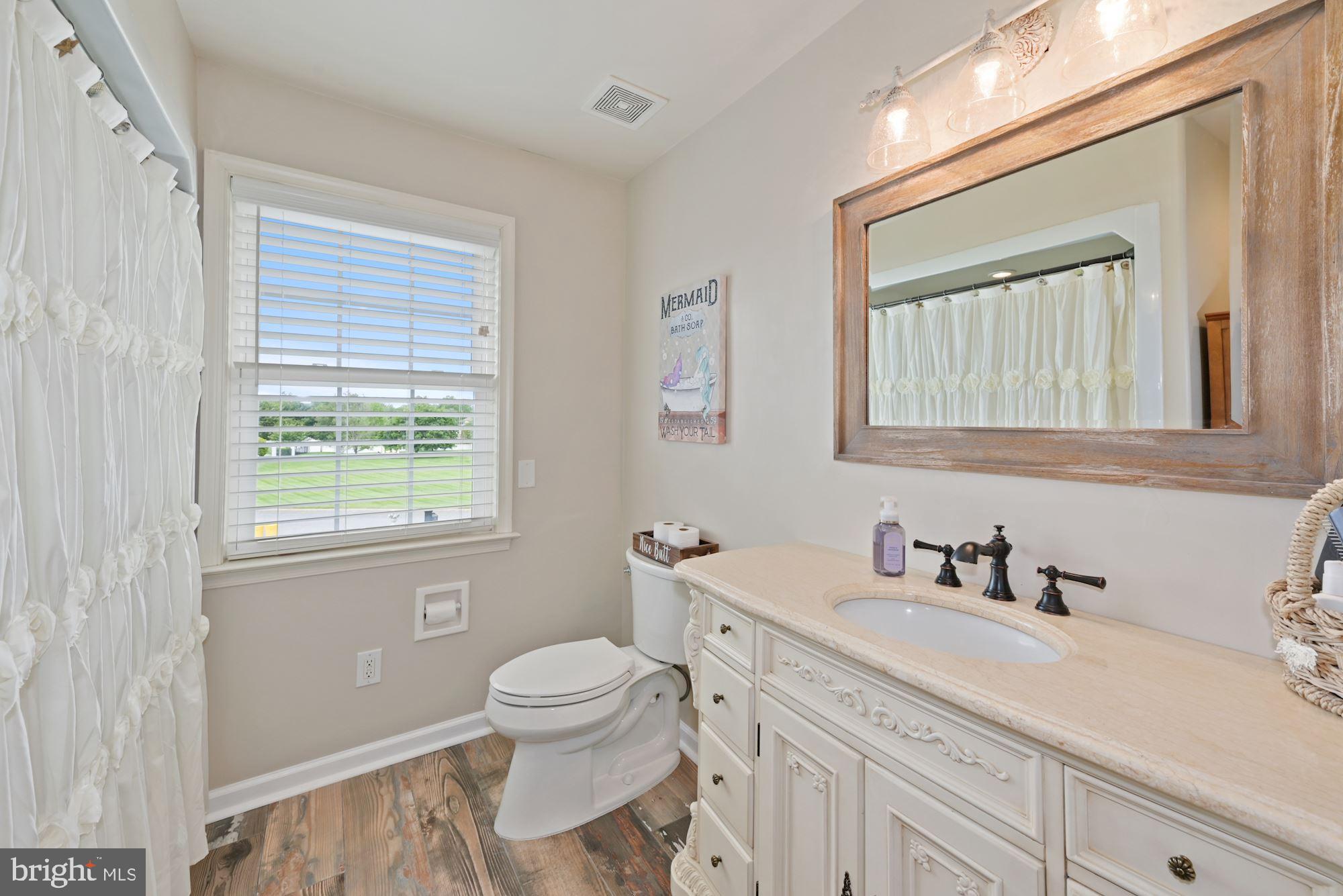 360 Chapel Heights Road Sewell, NJ 08080 - Photo 35 of 58 a bathroom with a toilet a sink a mirror a window and vanity