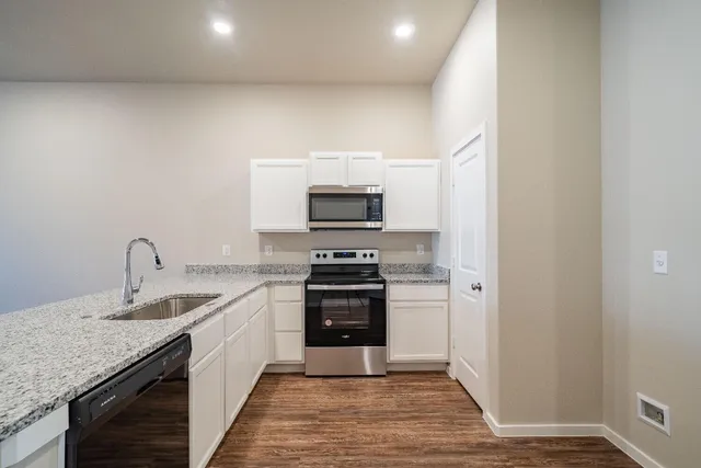 a kitchen with a sink and a stove top oven