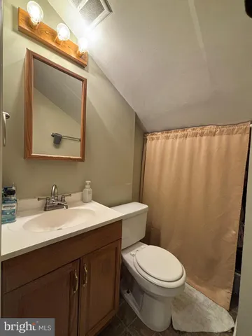 a bathroom with a toilet a sink and a mirror