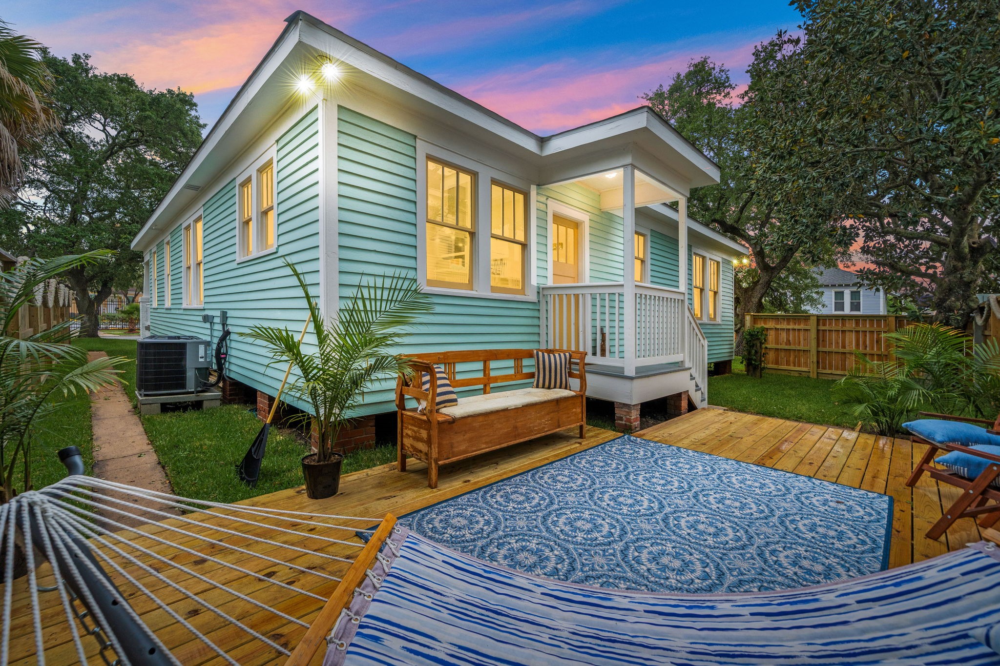 a backyard of a house with barbeque oven table and chairs