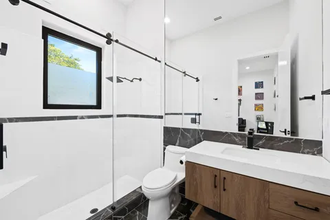 a view of a patio with a table and chairs under an umbrella
