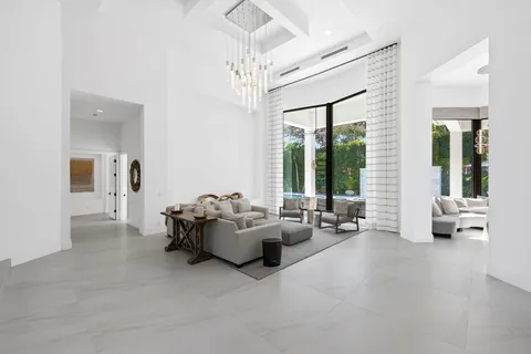 a living room with furniture tv and a window