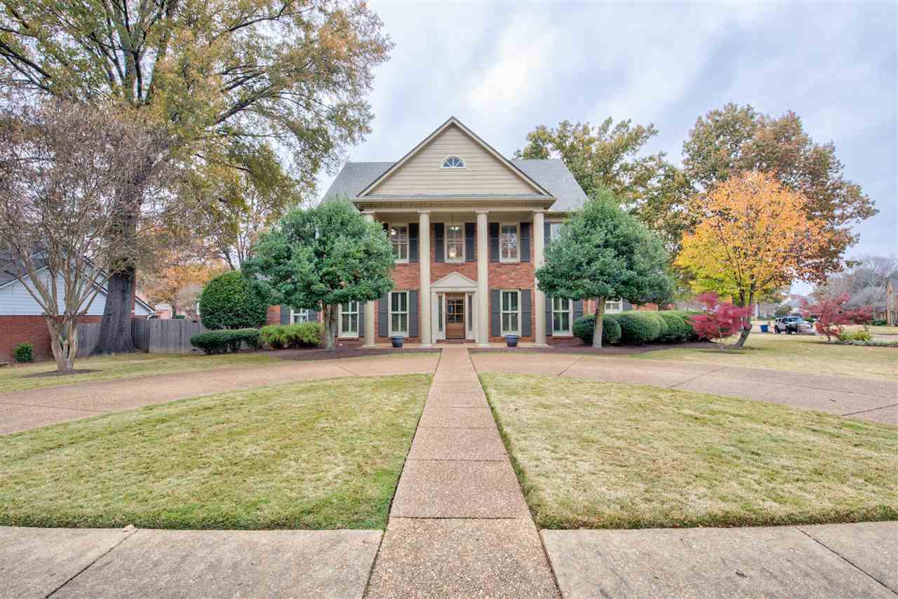 a front view of house with yard and green space