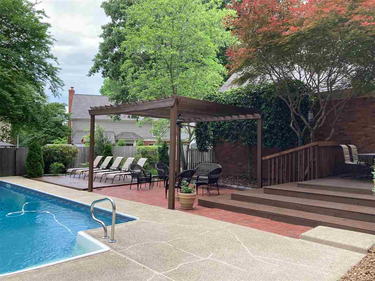 9162 Fox Ridge Road Germantown, TN 38139 - Photo 2 of 25 a view of a patio with a dining table and chairs with wooden floor and fence