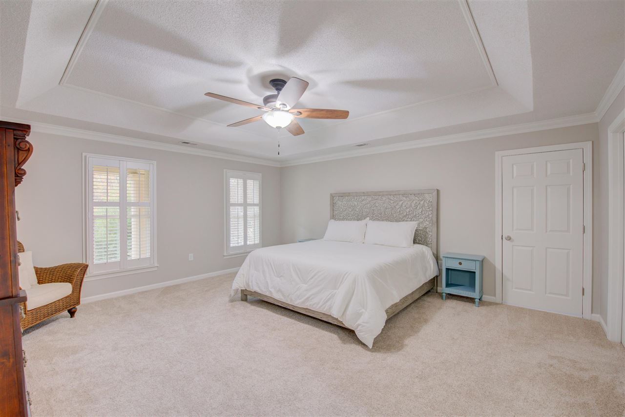 9162 Fox Ridge Road Germantown, TN 38139 - Photo 14 of 25 a spacious bedroom with a bed and a ceiling fan