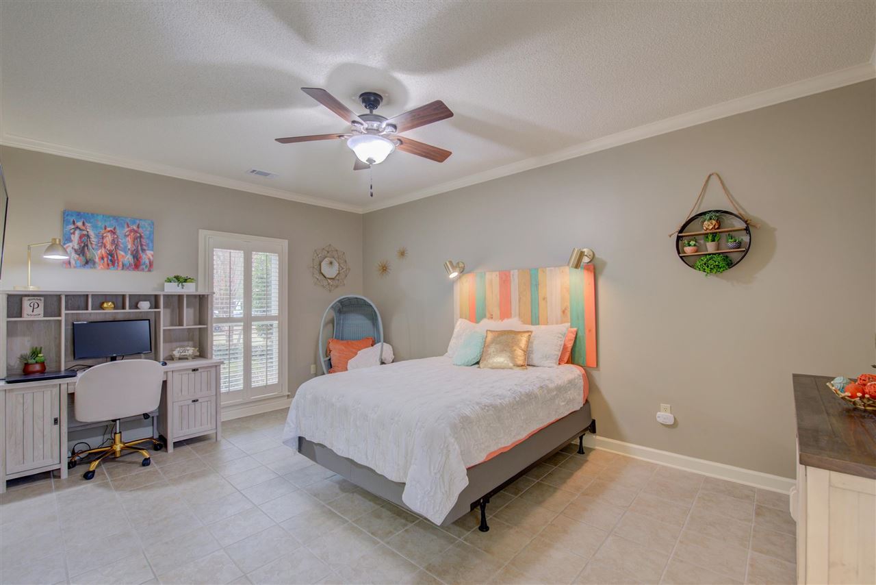 9162 Fox Ridge Road Germantown, TN 38139 - Photo 17 of 25 a bedroom with a bed and a chandelier