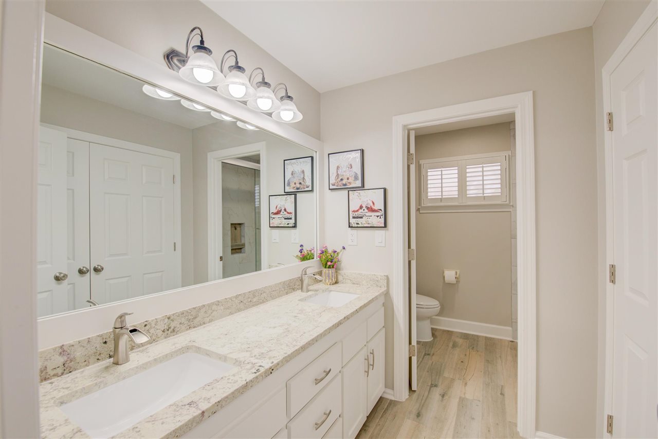 9162 Fox Ridge Road Germantown, TN 38139 - Photo 21 of 25 a spacious bathroom with a granite countertop sink a mirror and a shower