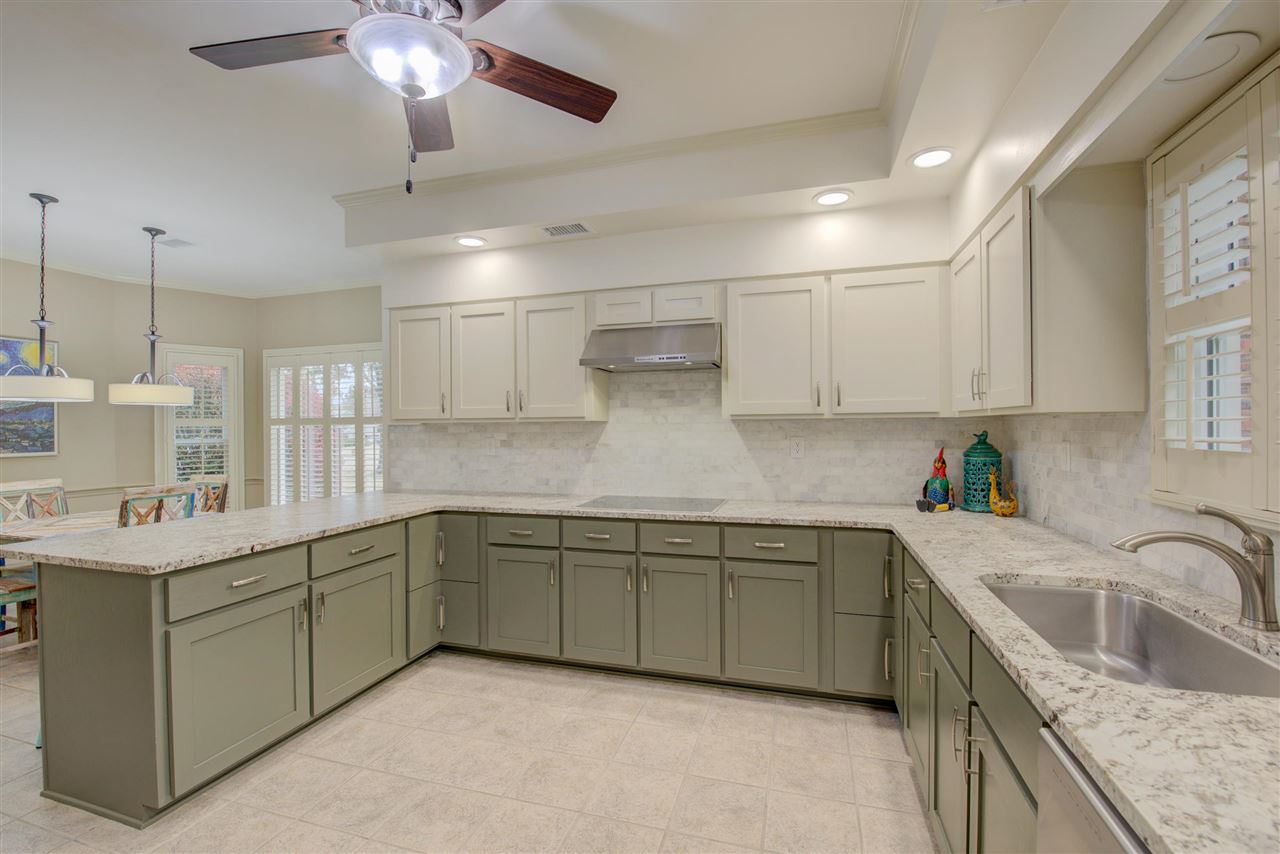 9162 Fox Ridge Road Germantown, TN 38139 - Photo 7 of 25 a kitchen with a sink dishwasher and white cabinets with wooden floor