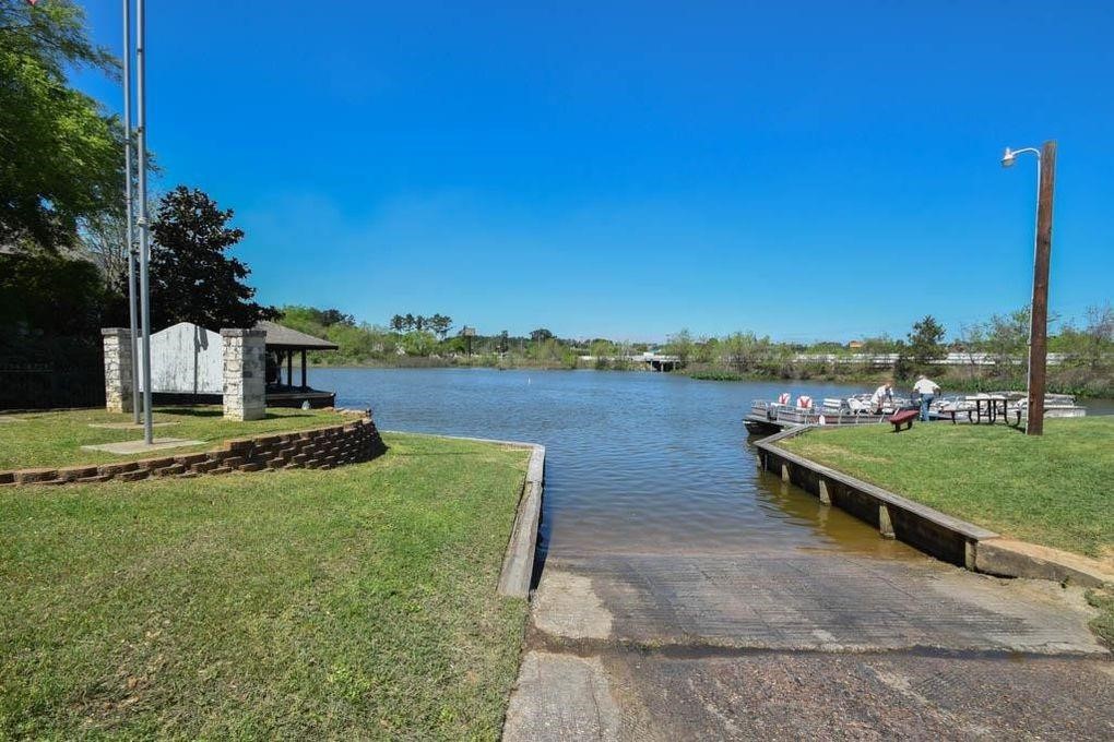 1513 Cheyenne Loop Conroe, TX 77316 - Photo 7 of 8 a view of a lake with a garden