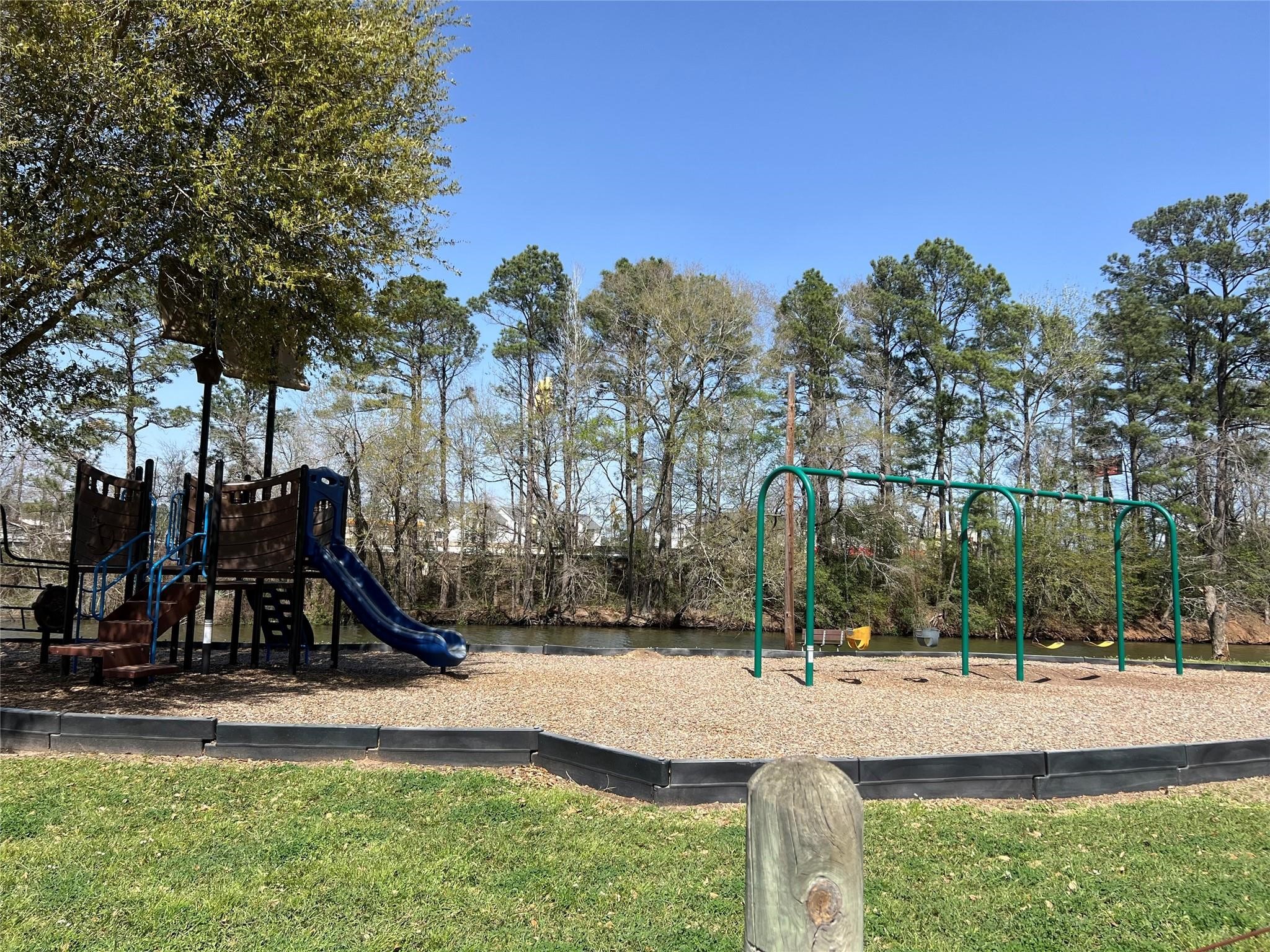 1513 Cheyenne Loop Conroe, TX 77316 - Photo 8 of 8 a view of a park with swings and slides