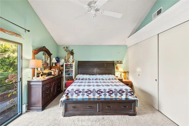 a view of a chair and table in backyard of the house